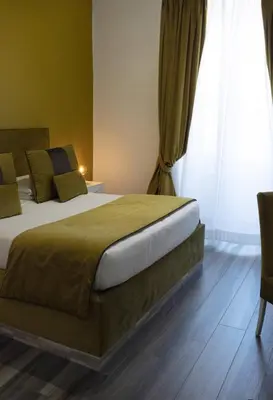 a bedroom with a bed and a large window at Le Stanze di Elisa in Rome
