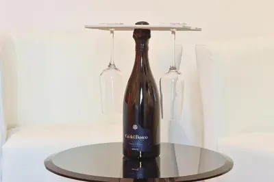 a bottle of wine on a table with two glasses at Le Stanze di Elisa in Rome