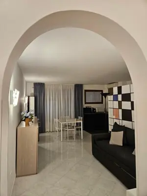 a living room with a couch and a table at Fermata San Pietro - appartamento con parcheggio in Rome