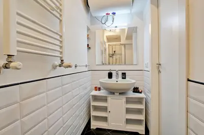a bathroom with a sink and a mirror at Fermata San Pietro - appartamento con parcheggio in Rome