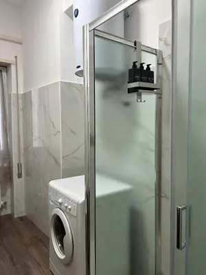 a washing machine in a bathroom with a glass door at San Pietro - Musei Vaticani Appartamento spazioso in Rome