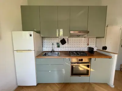a kitchen with a white refrigerator and a sink at Lotto 21 della Garbatella in Rome