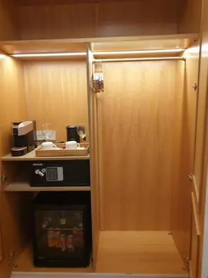 a small kitchen with a cupboard with a microwave at Appian Private Suites in Rome