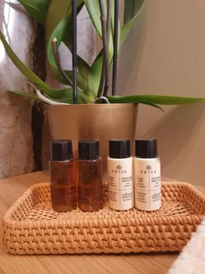 three bottles of essential oils sitting on a table with a plant at Appian Private Suites in Rome