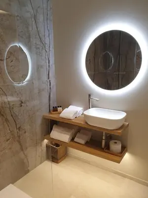 a bathroom with a sink and a mirror at Appian Private Suites in Rome
