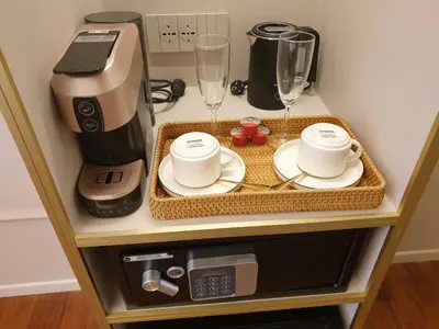 a table with a coffee maker and glasses on it at Appian Private Suites in Rome