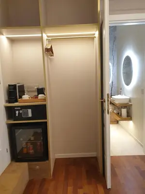 a bathroom with a sink and a toilet and a door at Appian Private Suites in Rome