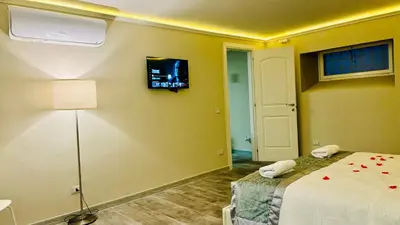 a bedroom with a bed and a tv on the wall at Maison Pantheon & Breakfast in Rome