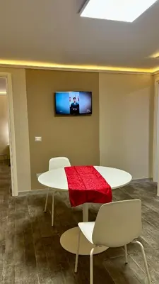 a room with a table and two chairs and a tv at Maison Pantheon & Breakfast in Rome