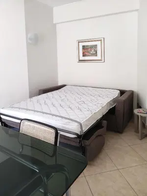 a bed in a room with a glass table at Oasi Ridolfi in Rome