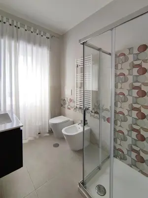 a bathroom with a shower and a toilet and a sink at Oasi Ridolfi in Rome