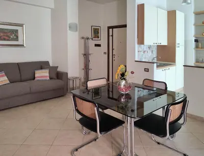 a living room with a glass table and chairs at Oasi Ridolfi in Rome