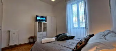 a bedroom with a bed and a television on a wall at Casa Linda in Rome