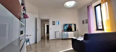 a living room with a blue couch and a tv at Casa Linda in Rome