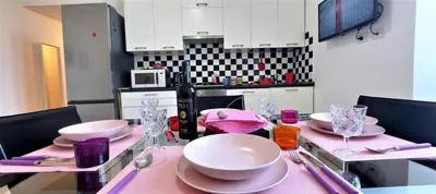 a dining room table with a pink table cloth at Casa Linda in Rome