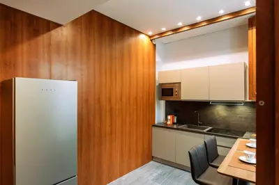 a kitchen with a refrigerator and a table at Arancio Luxury Accomodation in Rome