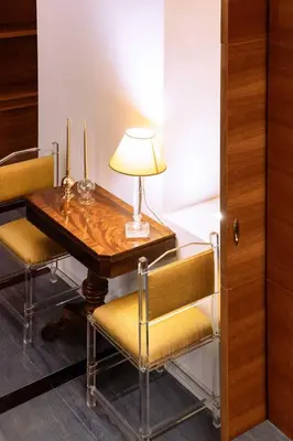 a table with two chairs and a lamp on it at Arancio Luxury Accomodation in Rome