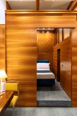 a bedroom with a bed in a wooden wall at Arancio Luxury Accomodation in Rome
