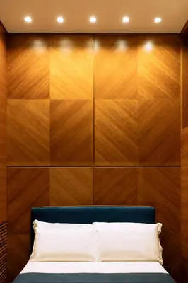 a bedroom with a wooden headboard and a bed at Arancio Luxury Accomodation in Rome