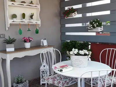 a patio with a table and chairs and plants at L'Attico di San Saba in Rome