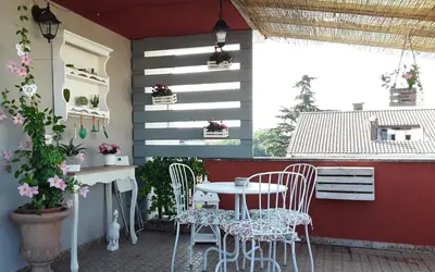 a patio with a table and chairs on a patio at L'Attico di San Saba in Rome