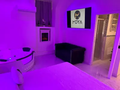 a room with a pink room with a sink and a tub at Moya Suites 2 - SPA in Camera in Rome