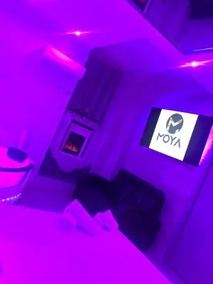a room with pink lights and a bed and a tv at Moya Suites 2 - SPA in Camera in Rome