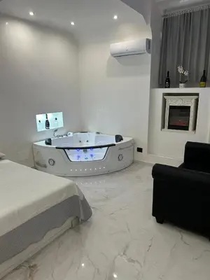 a white room with a tub and a fireplace at Moya Suites 2 - SPA in Camera in Rome