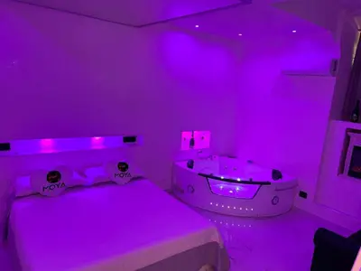 a purple room with a tub and a bed at Moya Suites 2 - SPA in Camera in Rome