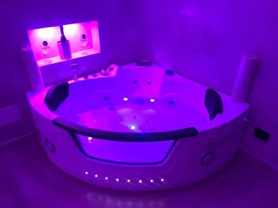 a purple bathroom with a tub with lights in it at Moya Suites 2 - SPA in Camera in Rome