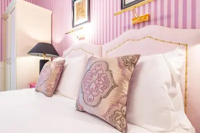a bedroom with a white bed with pillows at Catone Vatican Suites by Ghor in Rome