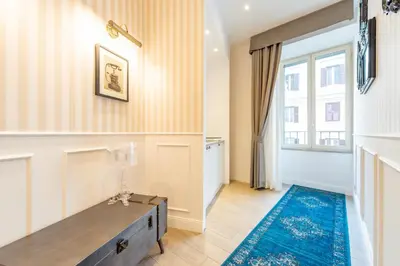 a living room with a table and a window at Catone Vatican Suites by Ghor in Rome