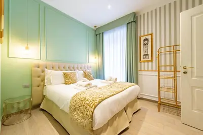 a bedroom with a large bed in a room at Catone Vatican Suites by Ghor in Rome