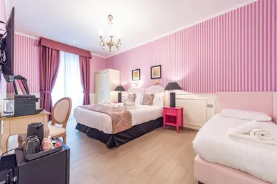 a hotel room with two beds with pink walls at Catone Vatican Suites by Ghor in Rome