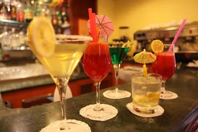 a group of four cocktails sitting on a bar at Augusta Lucilla Palace in Rome
