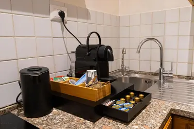 a kitchen counter with a tray of food and a sink at Sweet Navona Duplex Apartment in Rome