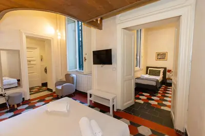 a room with a bed and a tv and a bedroom at Sweet Navona Duplex Apartment in Rome