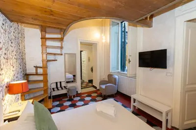 a bedroom with a bed and a staircase in a room at Sweet Navona Duplex Apartment in Rome