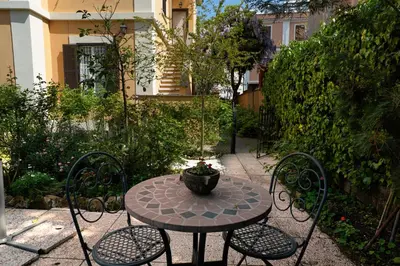 a patio table and chairs with a potted plant on it at Gianicolo Penny's Garden a Roma centro in Rome