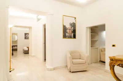 a living room with a chair and a mirror at Bonsignore Luxury Accomodation in Rome