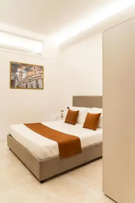 a bedroom with a large bed with brown pillows at Bonsignore Luxury Accomodation in Rome