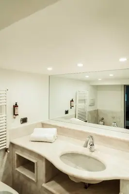 a bathroom with a sink and a large mirror at Bonsignore Luxury Accomodation in Rome