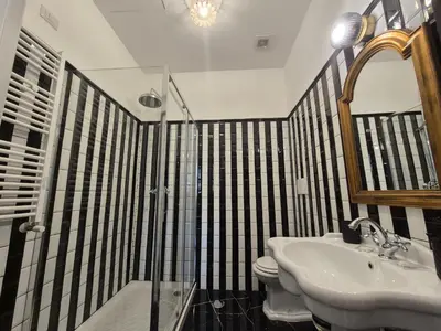 a bathroom with a sink and a shower and a toilet at HEBE Eternity Rooms in Rome