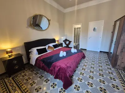 a bedroom with a large bed and a mirror at HEBE Eternity Rooms in Rome