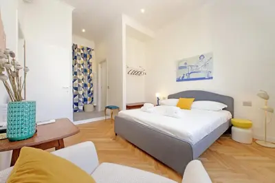 a bedroom with a bed and a living room at Scipioni in Rome