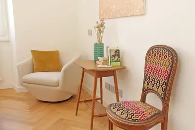 a chair and a table in a room with a chair and a chair at Scipioni in Rome