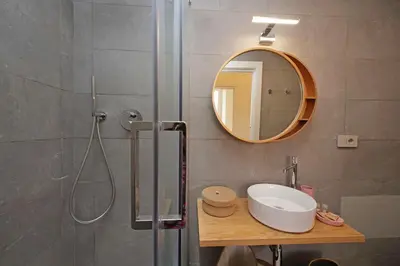 a bathroom with a shower with a sink and a mirror at Scipioni in Rome
