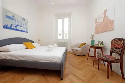 a bedroom with a bed and a table and a chair at Scipioni in Rome