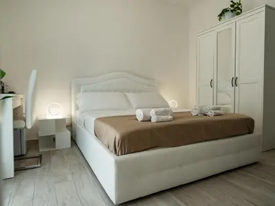 a bedroom with a white bed with two stuffed animals on it at Felix Rooms in Rome