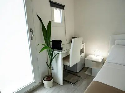 a small bedroom with a desk and a plant at Felix Rooms in Rome